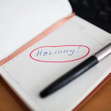 Notebook with the entry Holiday Stock Photos