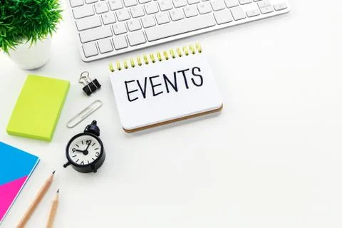 Notebook with events word on computer desk with pencil notepad and clock with Stock Photos