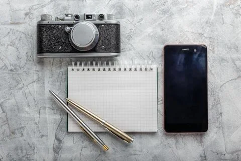 Notebook with film camera. Stock Photos
