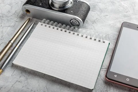 Notebook with film camera. Stock Photos