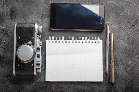 Notebook with film camera. Stock Photos