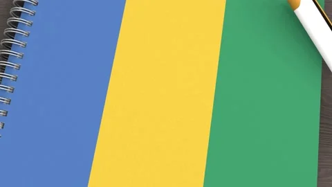 A notebook with the flag of Gabon and a lying pen Stock-Footage 167828072