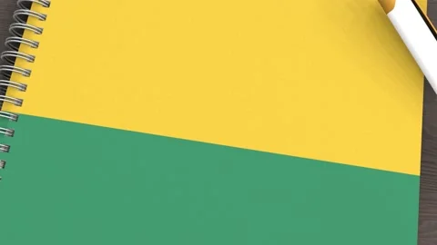 A notebook with the flag of Guinea and a lying pen Stock Footage 167828094