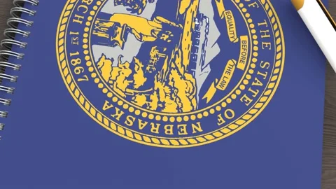 A notebook with the flag of Nebraska and a lying pen Video stock 167828451