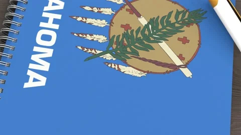 A notebook with the flag of Oklahoma and a lying pen Stock Footage 167828459