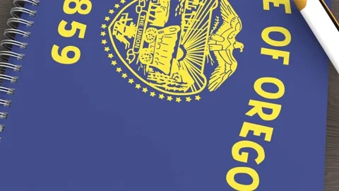 A notebook with the flag of Oregon and a lying pen Stock Footage 167828462