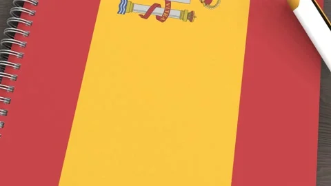 A notebook with the flag of Spain and a lying pen Stock Footage 167828302