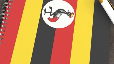 A notebook with the flag of Uganda and a lying pen Stock Footage 167828355