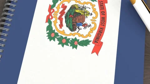 A notebook with the flag of West Virginia and a lying pen Stock Footage 167828479