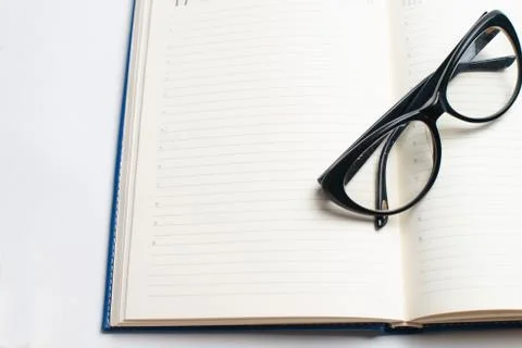 Notebook with glasses and pen, Book with glasses, Blue notebook with glasses, Stock Photos