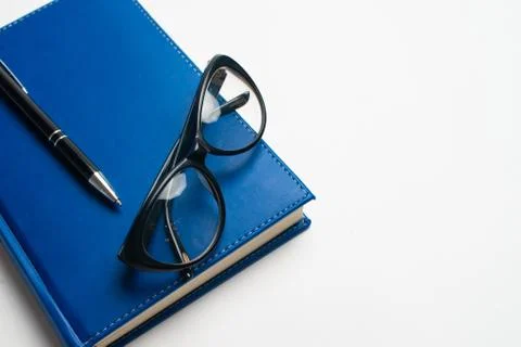 Notebook with glasses and pen, Book with glasses, Blue notebook with glasses, Stock Photos