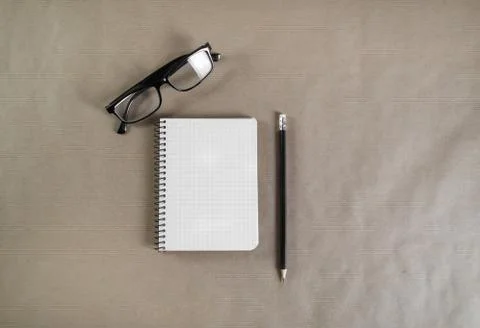 Notebook, glasses and pencil Stock Photos