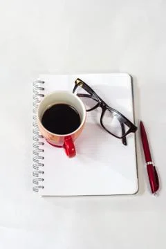 Notebook glasses coffee cup Stock Photos