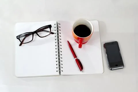 Notebook glasses coffee cup Stock Photos