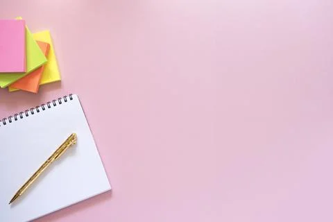 Notebook with gold pen and stack of stickers overlay Stock Photos