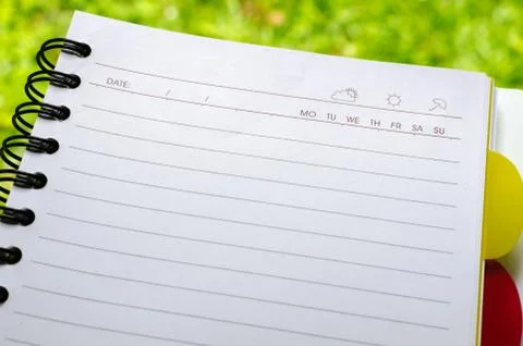 Notebook on the green grass. Stock Photos