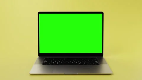 Notebook with green screen on display for chromakeying with yellow background Stock Footage 254723763