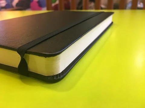 Notebook on the green table Stock Photos