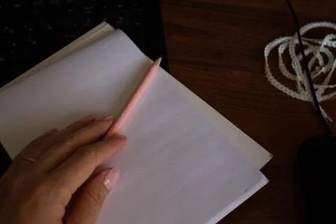 Notebook, hand, pencil on the desktop Stock Photos