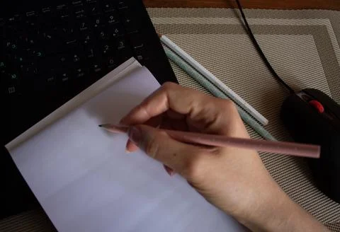 Notebook, hand, pencils on the desktop Stock Photos