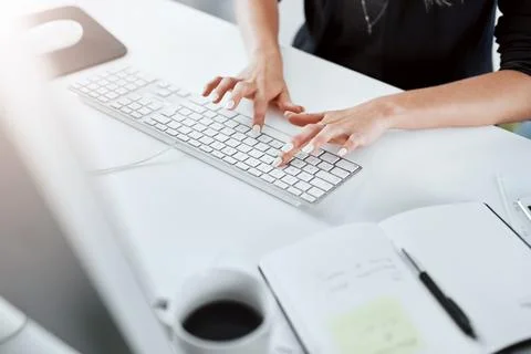 Notebook, hands and typing on desk, keyboard and computer with contract for deal 写真素材