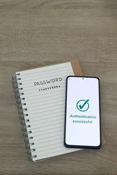 Notebook with Handwritten Password and Smartphone Showing Authentication Su.. Stock Photos