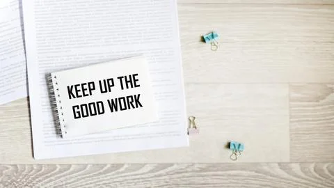 A notebook with the inscription "Keep up the good work" on a light background Stock Photos