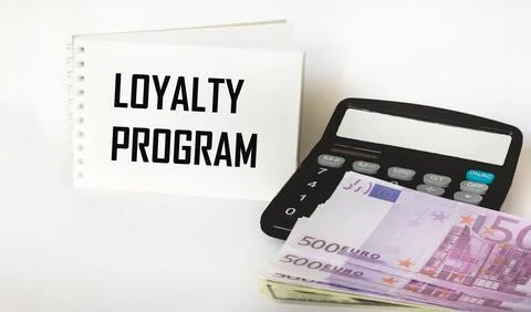 A notebook with the inscription Loyalty program with a calculator and euro ba Foto stock