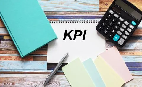 Notebook with KPI text on the table with calculator, stickers and buryus note Stock Photos