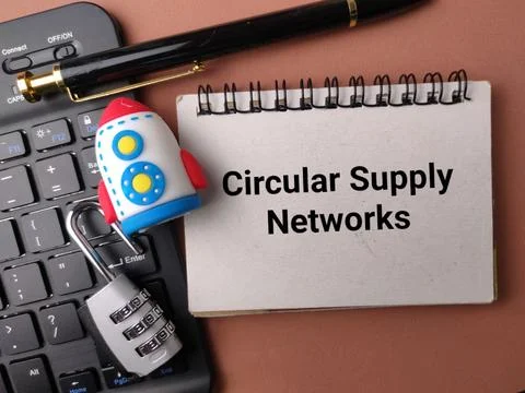 A notebook labeled Circular Supply Networks lies with a rocket, lock, keybo.. Stock Photos