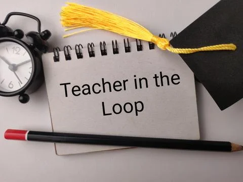 A notebook labeled Teacher in the Loop lies with a clock, graduation cap, a.. Stock Photos