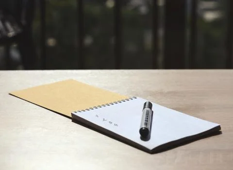 Notebook with list on the table Stock Photos