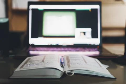 Notebook lying next to the computer Stock Photos