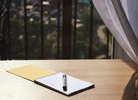 Notebook with a marker on the table Stock Photos