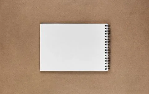 A notebook in a minimal style top view. Isolated brown background of recycled Stock Photos