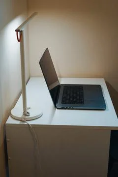 Notebook on office table with lamp light home office work study technology Stock Photos