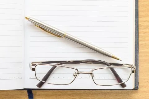 Notebook open blank page and Eyeglasses Stock Photos