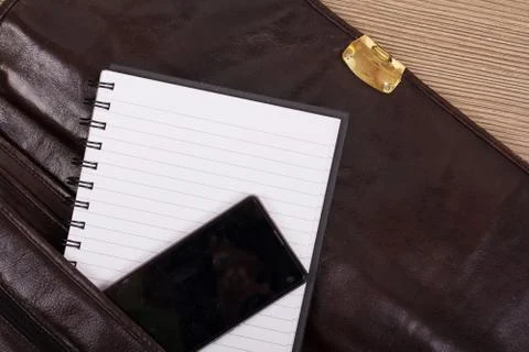 Notebook in an open brown leather briefcase Stock Photos