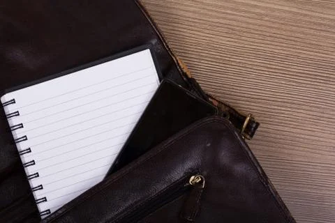 Notebook in an open brown leather briefcase Stock Photos