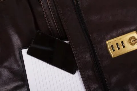 Notebook in an open brown leather briefcase Stock Photos