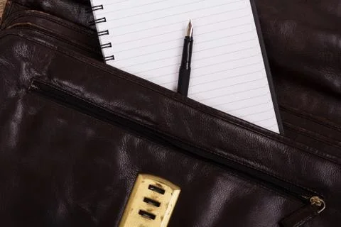 Notebook in an open brown leather briefcase Stock Photos