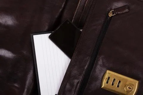 Notebook in an open brown leather briefcase Stock Photos
