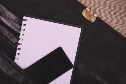 Notebook in an open brown leather briefcase Vintage Retro Filter. Stock Photos