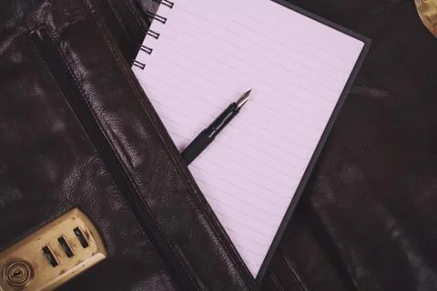 Notebook in an open brown leather briefcase Vintage Retro Filter. Stock Photos