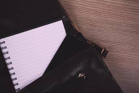 Notebook in an open brown leather briefcase Vintage Retro Filter. Stock Photos