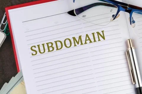 A notebook opened to a blank page displays the term subdomain in bold letters Photos