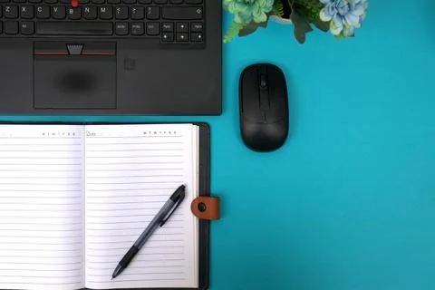 The notebook opens on top of the laptop Stock Photos