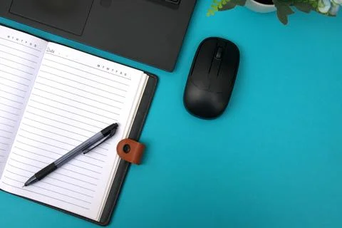 The notebook opens on top of the laptop Stock Photos