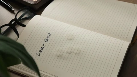 A notebook opens, in which is written dear God... Stock Footage 259825756
