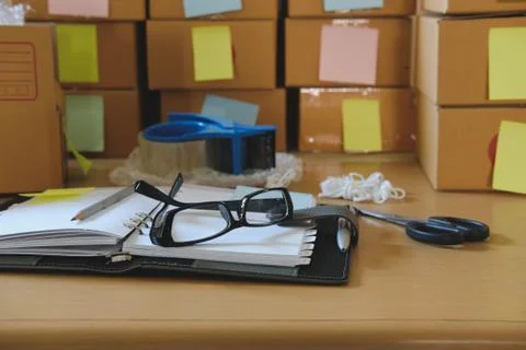 Notebook, packing accessories at workplace of startup small business owner. c Stock Photos